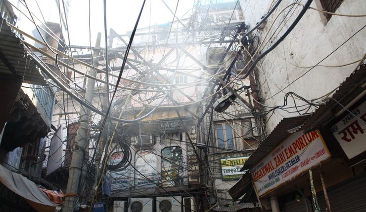 Many intersecting power lines in a backyard in Old Delhi, India, 2013, photo by Ira Sarma.