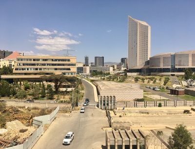 A picture of the Julius Nyerere Building for Peace and Security in Addis Ababa on the left side, and the African Union Headquarters on the right.