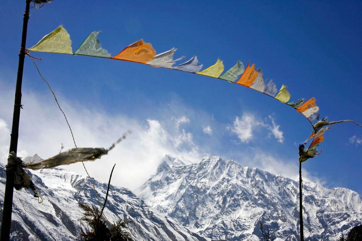 enlarge the image: The stock photo depicts praying flags floating in the wind in the Annapurna, Nepal